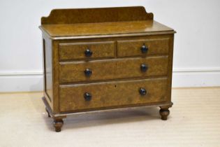 A Victorian scrumbled pine chest of drawers with raised back above two short over two long drawers