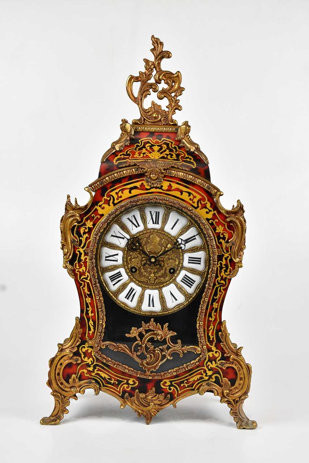 A reproduction Boulle work effect mantel clock in the Rococo style, the dial set with Roman