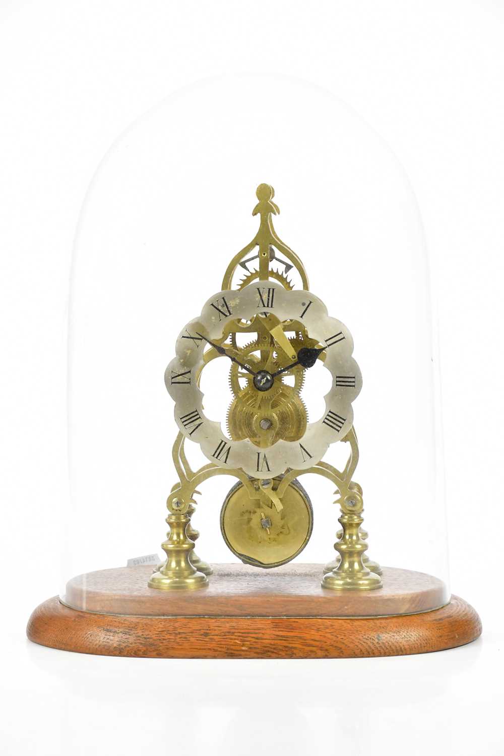 An early 20th century skeleton clock, with silvered chapter ring with Roman numerals, with fusee