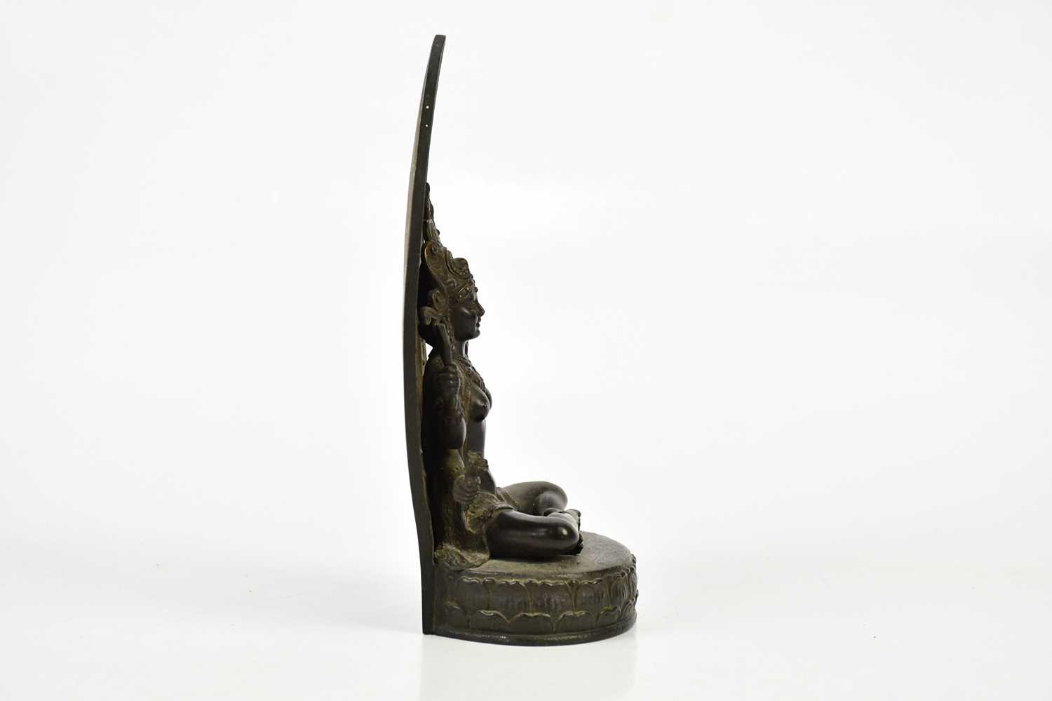 A Chinese bronze figure of a female deity with four arms, with leaf shaped back plate and oval base, - Image 4 of 6