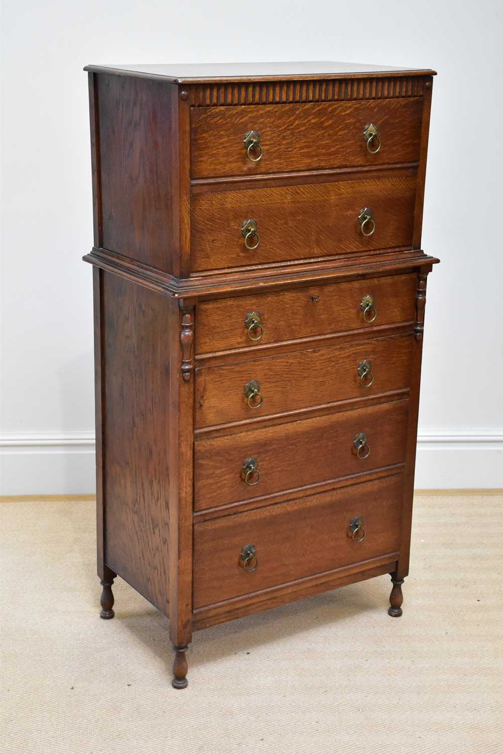 An early 20th century oak six drawer chest, on column supports, width 76cm, depth 46cm, height