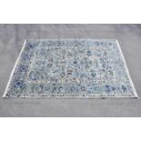 A blue ground wool carpet with floral geometric pattern, 190 x 295cm.