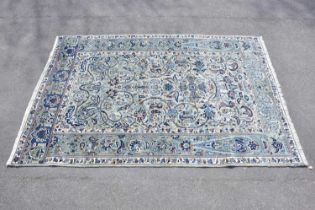 A blue ground wool carpet with floral geometric pattern, 190 x 295cm.