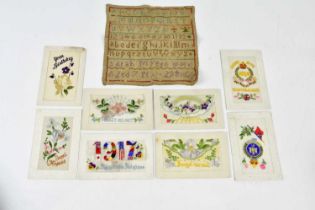 A 19th century alphabet sampler together with a mixed collection of WWI postcards.