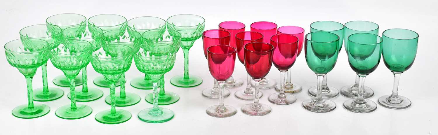 A set of twelve 1930s cut green glass wine glasses, height 12.5cm, with eight late Victorian ruby