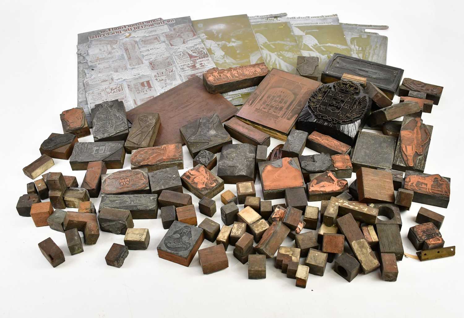 A collection of metal and wood printing blocks including some copper examples, and five larger