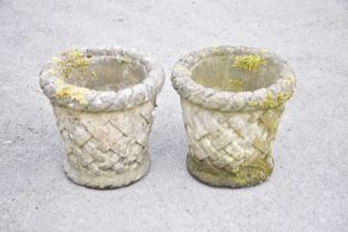 A pair of reconstitued stone planters with relief lattice style decoration, height 40cm.