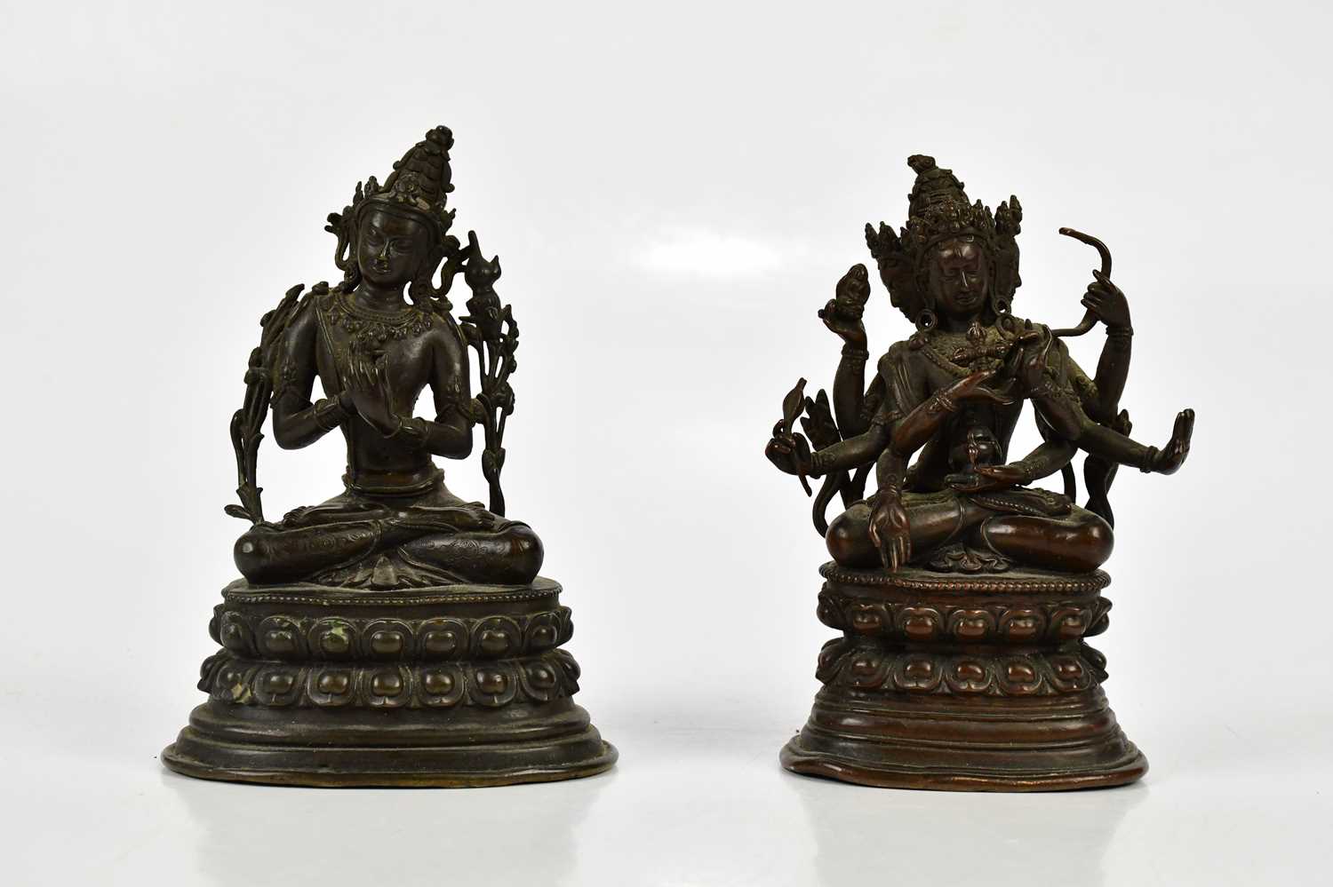 A Chinese bronze figure of Jnana Dakini, with six arms, on lotus base, height 14cm, with a similar
