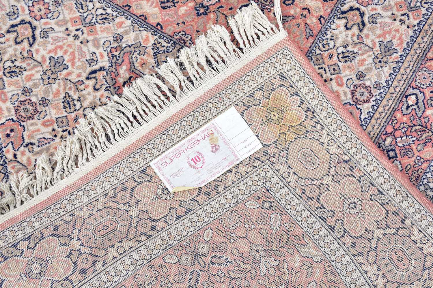 A Super Keshan rug with floral decoration on a salmon pink ground, 240 x 170cm. - Image 3 of 3