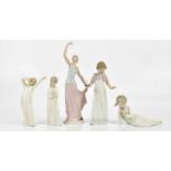 NAO; five figures including a ballerina, height 35cm, a girl holding a chamberstick, height 26cm,