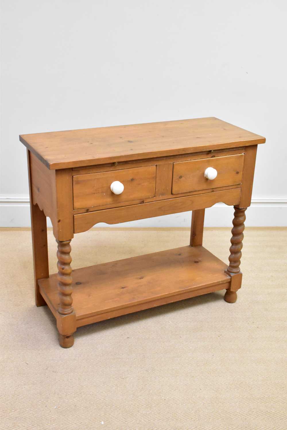 A modern pine two drawer two tier side table, height 87cm, width 101cm, depth 43cm.