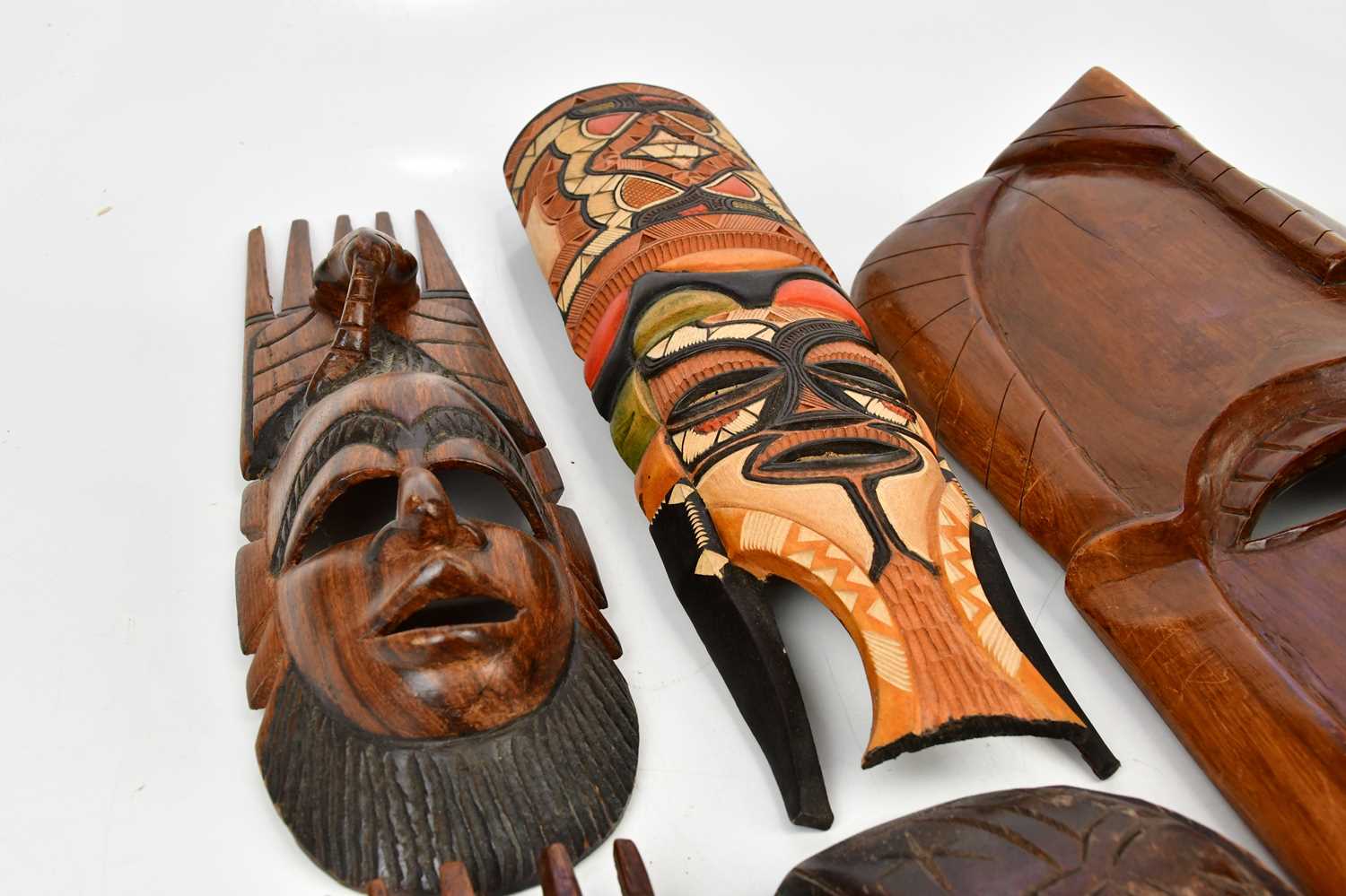 A collection of six decorative African masks, largest 63cm, together with animal hair fly swatter. - Image 3 of 5