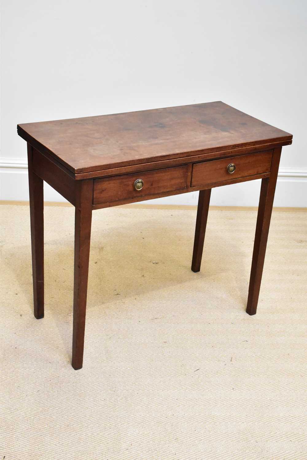 A Georgian mahogany fold-over two drawer tea table on square legs, width 86cm, depth 42cm, height