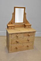 An old stripped pine mirror back dressing table with an arrangement of six drawers on plinth base,