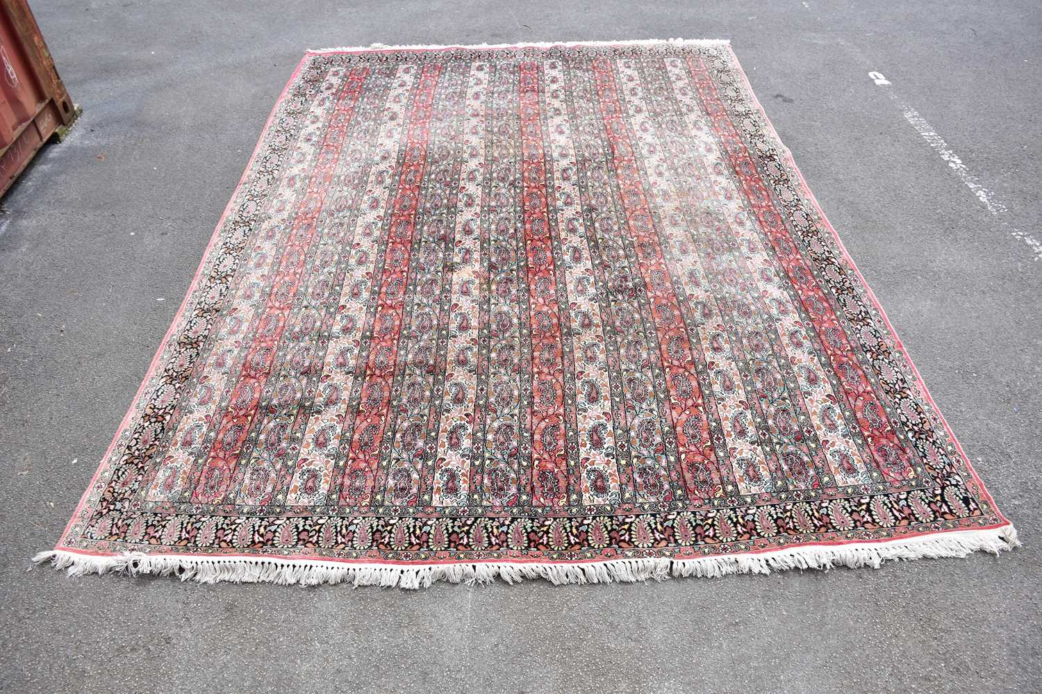 A large pink ground Eastern style carpet with paisley pattern design, 260 x 390cm.