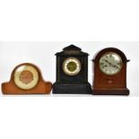 A Victorian slate mantel clock of architectural form with applied brass panels, the dial set with