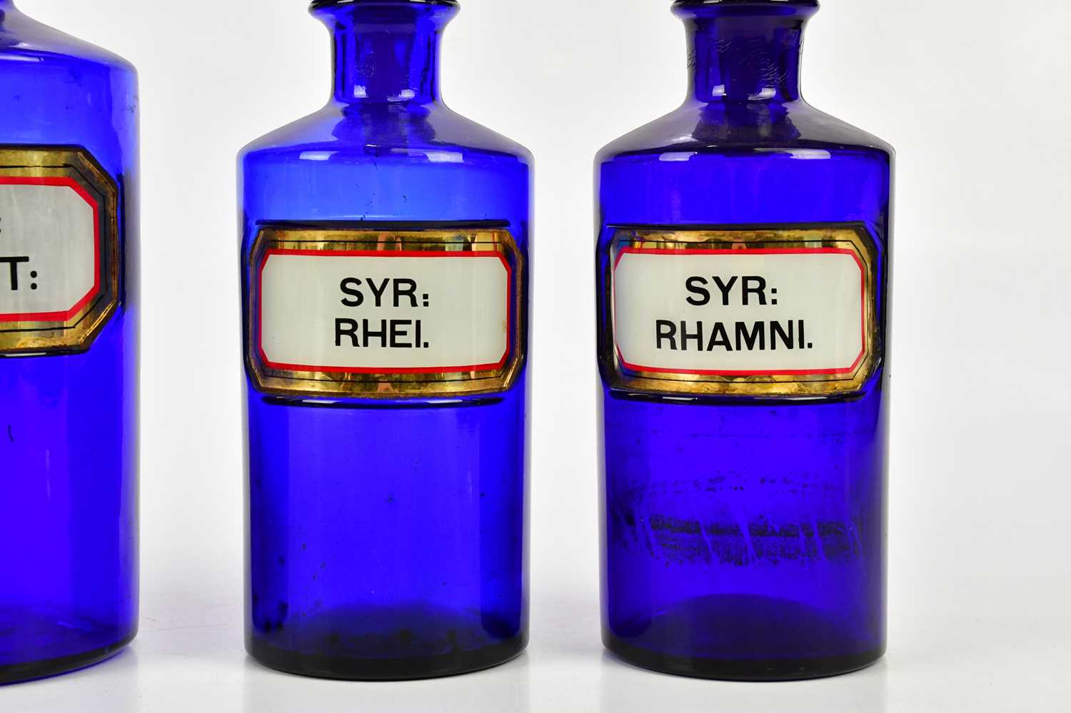 Four 19th century blue glass pharmacy bottles with labels and dummy stoppers, height of largest - Image 3 of 3
