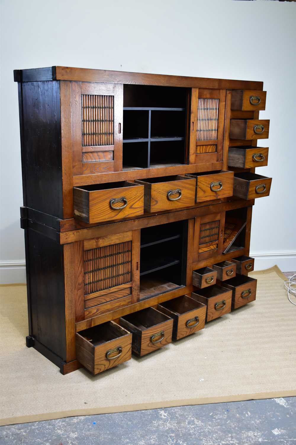 A 20th century Chinese elm cabinet of large proportions with an arrangement of sliding doors and - Image 2 of 3