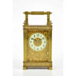 A brass cased carriage clock, the white enamel dial set with Roman numerals, height 15cm.