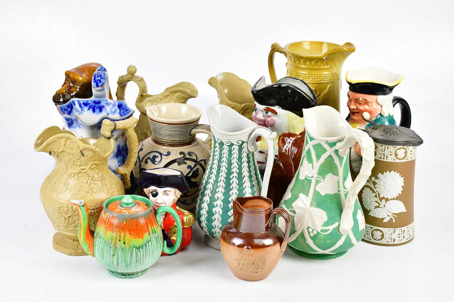 A collection of fourteen 19th century and later decorative jugs including two Toby Jugs and a