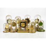 A collection of nine anniversary clocks, under perspex domes, with a Schatz mantel clock with