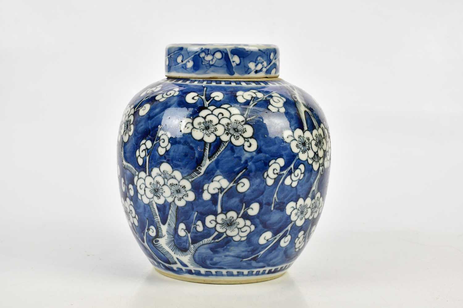 A late 19th century Chinese blue and white porcelain ginger jar and cover with prunus flowers, bears