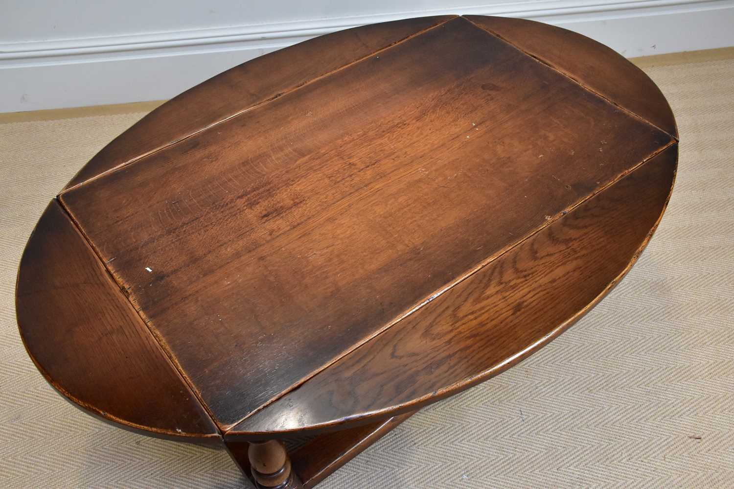 A reproduction oak drop-leaf coffee table of rectangular form, on bun feet, width 95cm, height - Image 2 of 3
