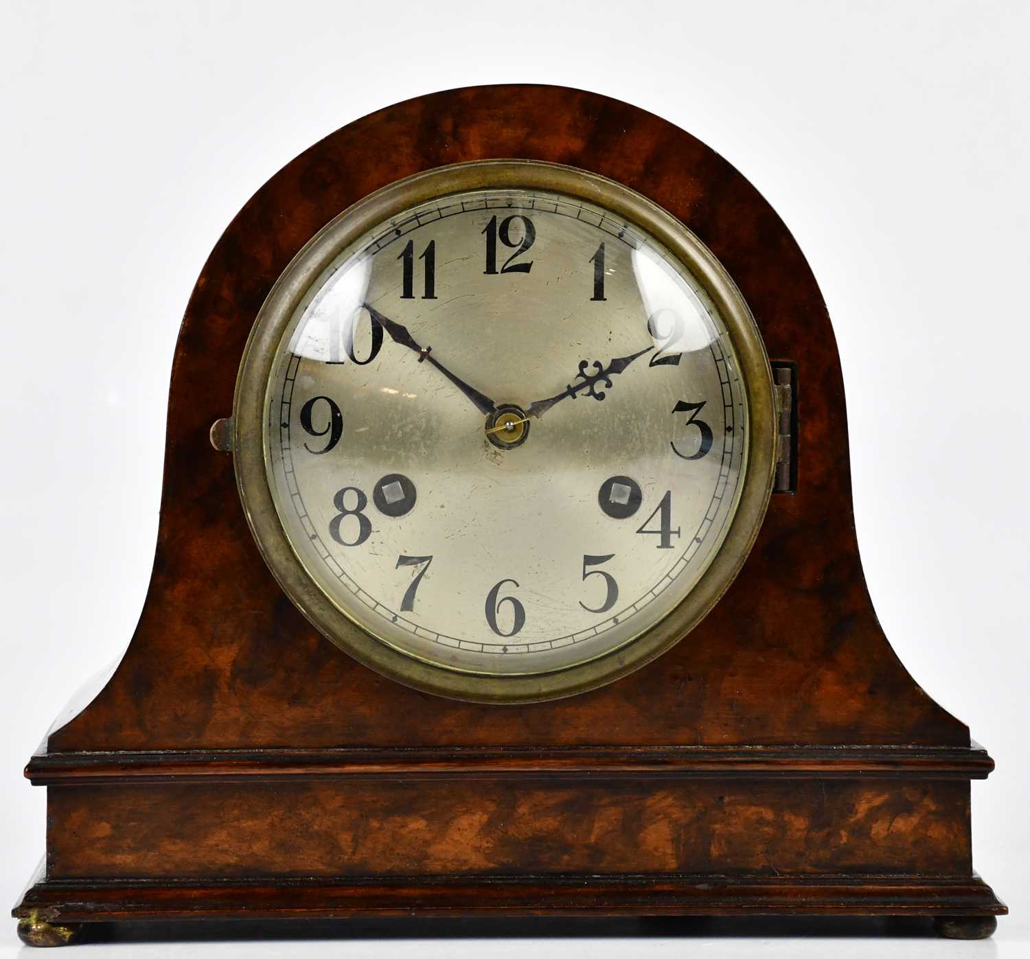 A 1930s walnut mantel clock with silvered dial set with Arabic numerals, with German movement,