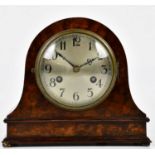 A 1930s walnut mantel clock with silvered dial set with Arabic numerals, with German movement,