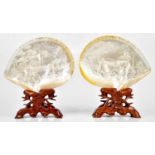 A pair of Chinese mother of pearl shells with carved decoration of figures in garden and landscape