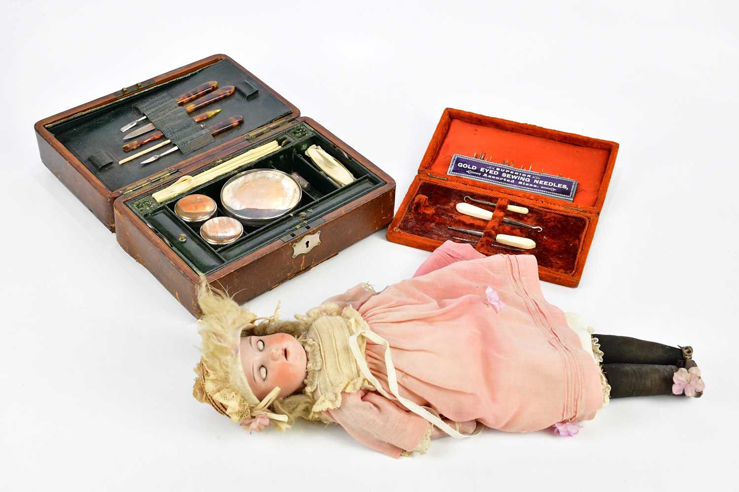 A Victorian leather travelling vanity set, the hinged cover enclosing fitted compartments and