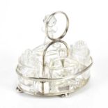 KEMP BROTHERS; a George V hallmarked silver oval cruet stand, stamped London 1927, with four glass