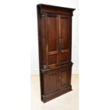 A George III oak corner cupboard, with two panelled doors flanked by fluted pilasters, above two