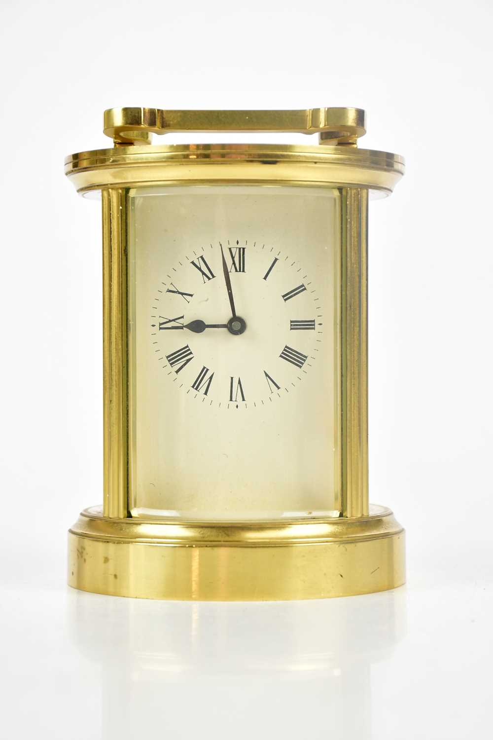 A modern brass circular carriage timepiece, with Roman numeral dial, height 12.5cm.