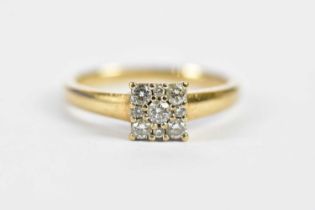 A 9ct yellow gold nine stone diamond ring in square claw setting, total diamond weight 0.24cts, size