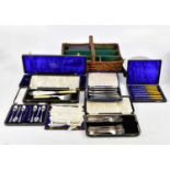 A collection of assorted silver plated cutlery, predominantly cased, a diamond cut throat razor,