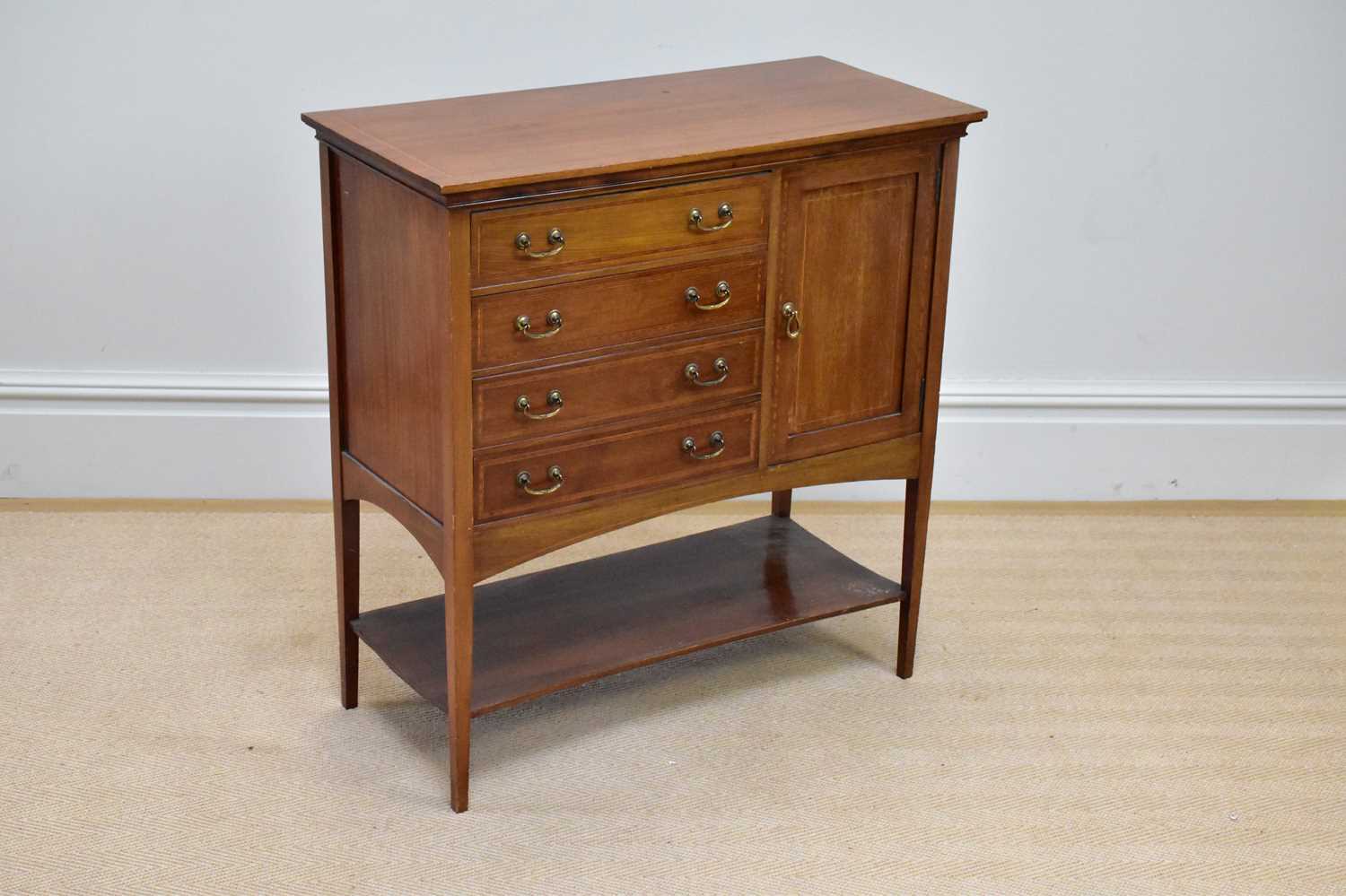 An Edwardian inlaid mahogany music cabinet with four drawers flanked on one side by a single