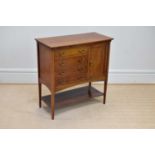 An Edwardian inlaid mahogany music cabinet with four drawers flanked on one side by a single