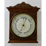 An early 20th century carved oak aneroid barometer, dial signed 'Bradford', 37 x 30cm.