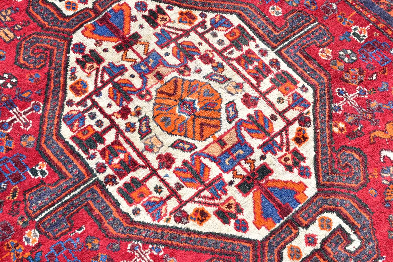 A red ground wool rug with central geometric pattern, 209 x 138cm. - Image 2 of 3