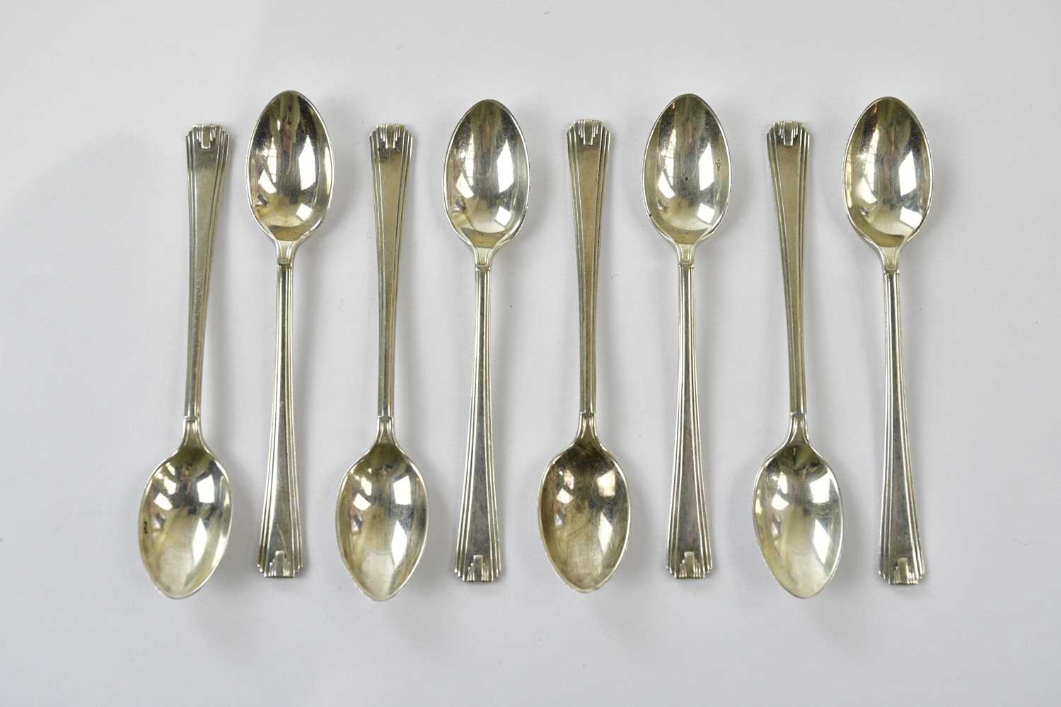 C W FLETCHER & SONS LTD; a set of eight George VI hallmarked silver teaspoons, with cast Art Nouveau