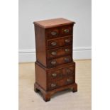 A reproduction small sized walnut chest of six drawers, on bracket feet, width 40cm, depth 28cm,