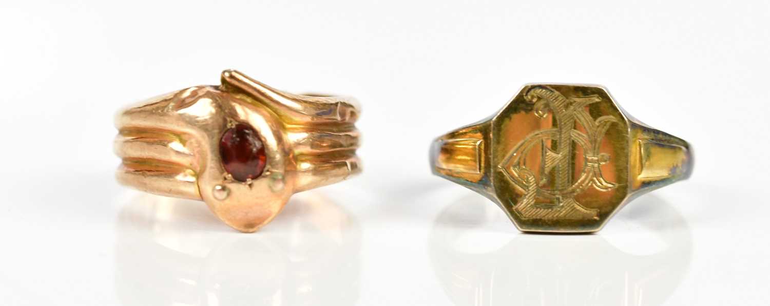 A 9ct yellow gold garnet set ring in the form of a stylised snake, size M, weight 2.2g, together
