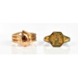 A 9ct yellow gold garnet set ring in the form of a stylised snake, size M, weight 2.2g, together