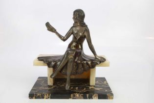 An Art Deco style spelter figure of seated girl holding a bird, on marble base, height 32cm.