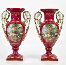 A pair of 20th century Continental porcelain twin handled pedestal vases, transfer printed with