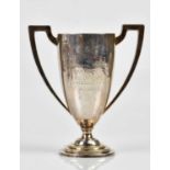 GLADWIN LTD; a George V hallmarked silver twin handled pedestal trophy cup on stepped base,