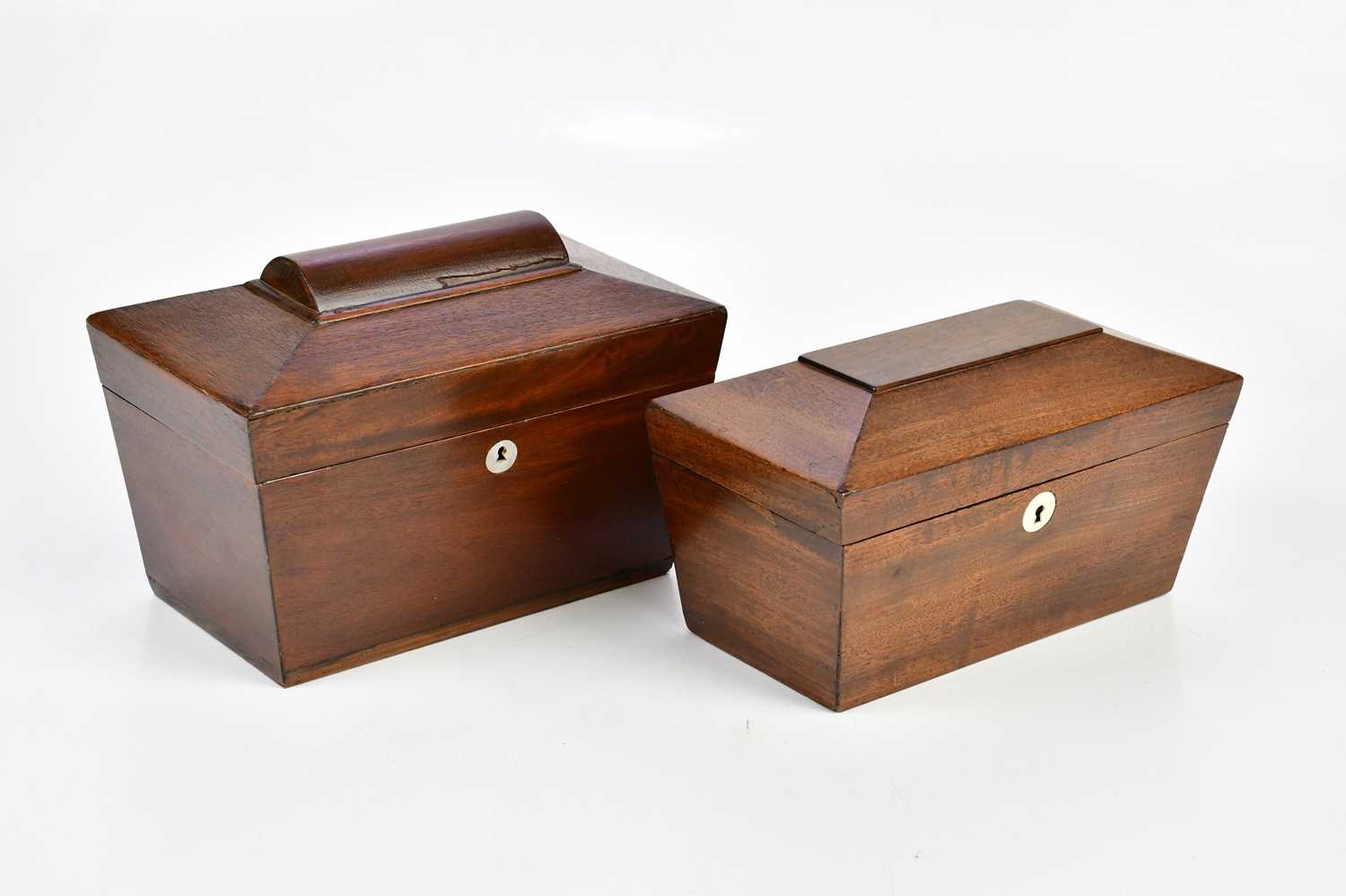 Two Victorian mahogany sarcophagus shaped tea caddies, the larger example with mother of pearl