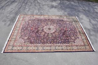 A blue ground wool carpet with geometric central pattern, 393 x 296cm.