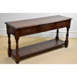 A 20th century three drawer oak dresser base, height 72cm, width 150cm, depth 46cm.